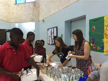 Volunteers serving treats to children in classroom