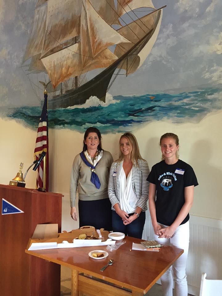 Volunteer recognition ceremony at yacht club with nautical backdrop